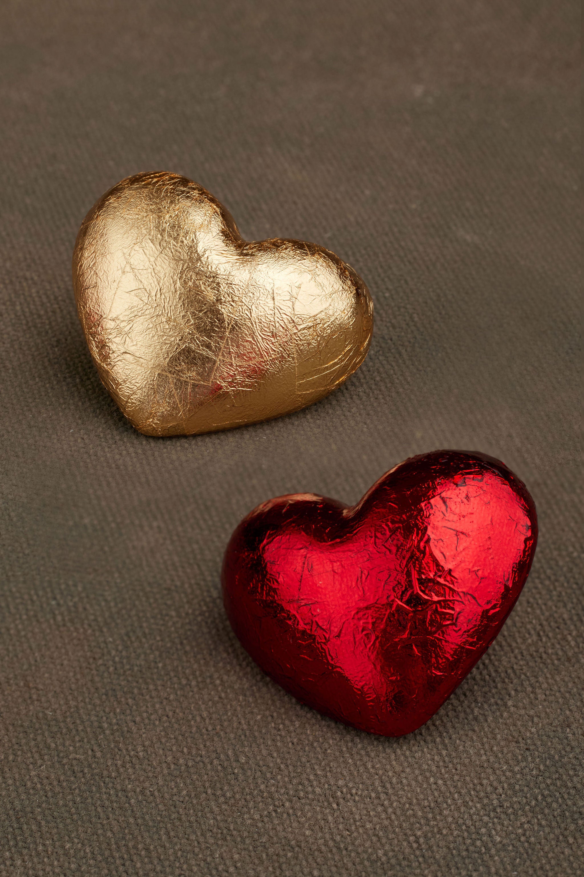 Close-up of AKER gold and red foil earrings
