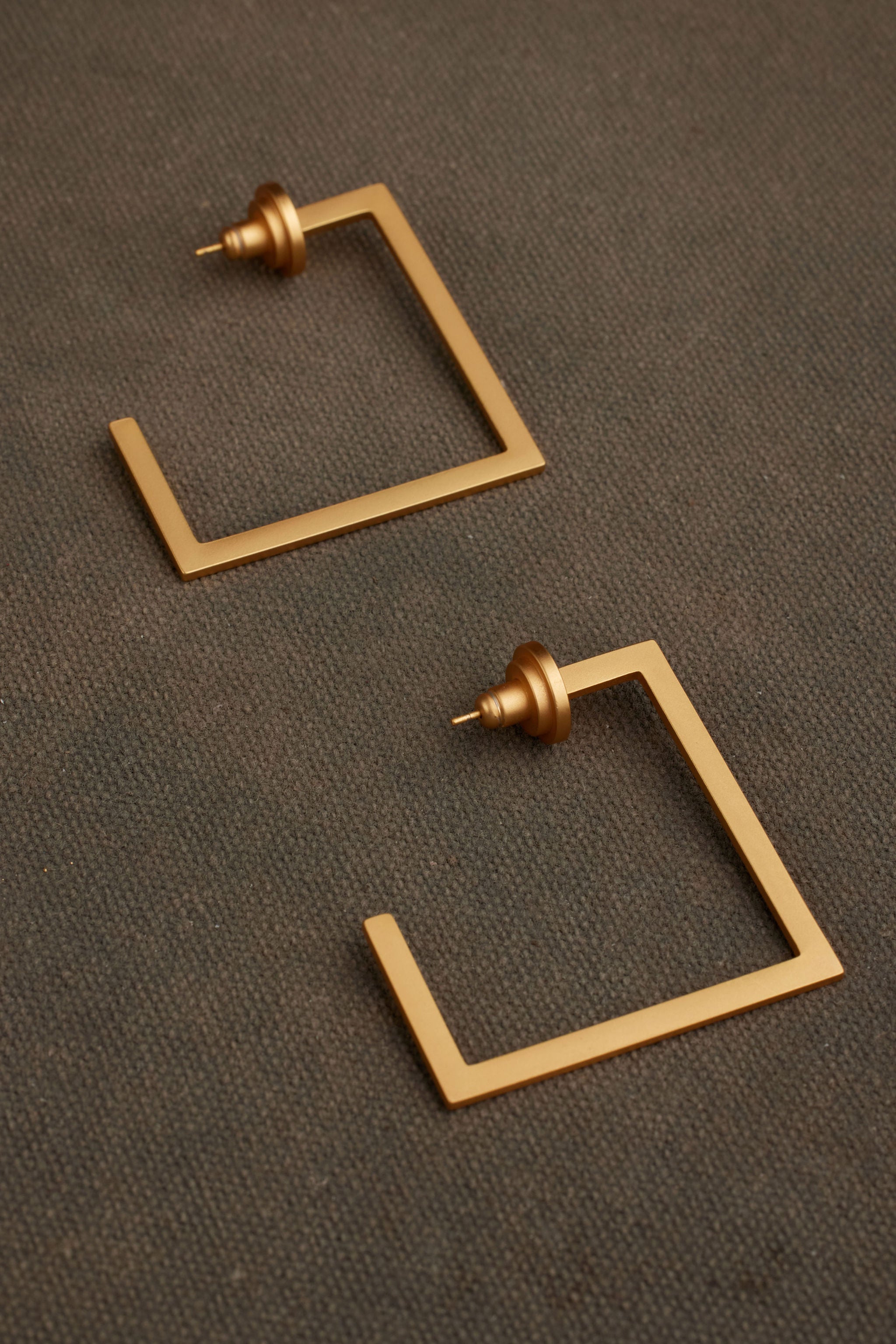 RAEN gold earrings close-up